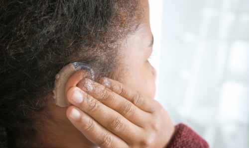 Child wearing a hearing aid 
